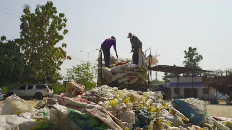 Worker people working on stack of different types of large garbage dump, plas 動画素材 168278273