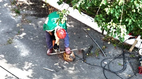 The worker performs cutting of metal rods with a grinder Stock Footage 246438517