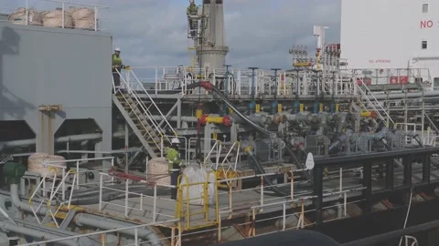 Worker performs rigging operations aboard industrial tanker Stock-Footage 130995008
