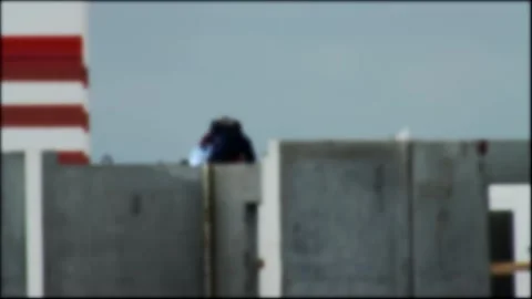Worker performs welding activity on concrete wall at construction site, bright Stock Footage 329622537