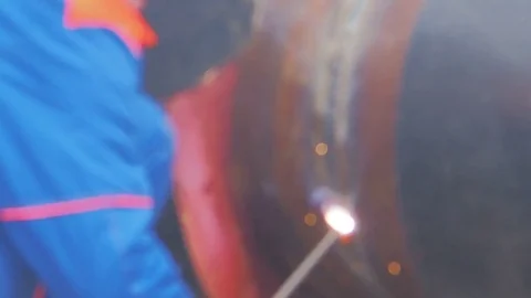A worker performs welding of metal pipe Stock Footage 76796415