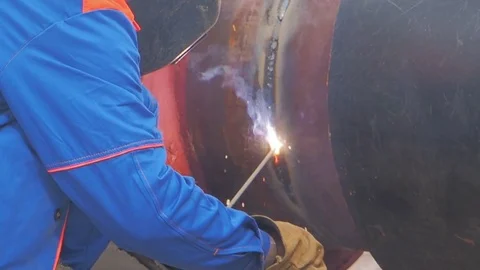 A worker performs welding of metal pipe Stock Footage 76796437