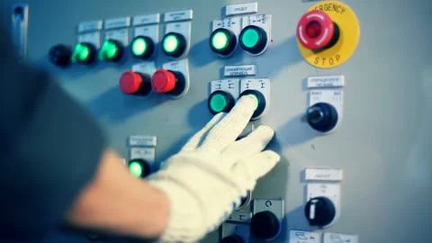 The worker performs work on the industrial equipment by pressing the buttons Stock Footage 92200009