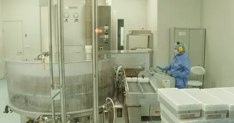 Worker At Pharmaceutical Factory. Lab technician working inside a pharmaceutical Video stock 101097841