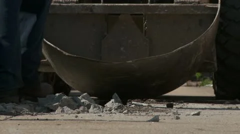 Worker picking up concrete debris on sidewalk Stock Footage 10975485