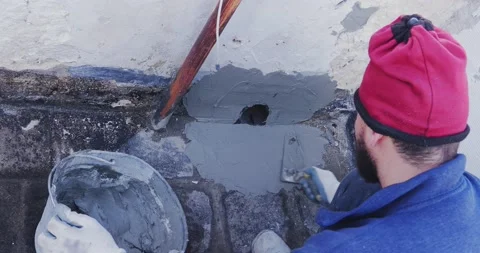 Worker places a PVC sleeve with quick-setting mortar for draining rainwater f 스톡 동영상 168349165