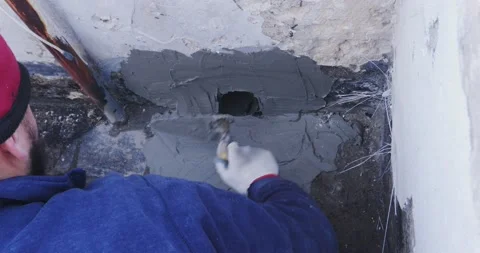 Worker places a PVC sleeve with quick-setting mortar for draining rainwater f 스톡 동영상 168349177