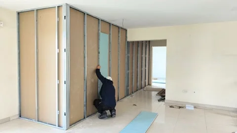 Worker placing blue plasterboard in the reform of an apartment Stock Footage 201464028