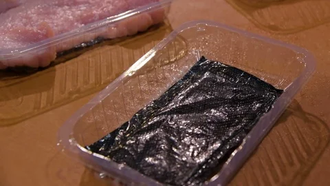 Worker placing meat in a package Stock Footage 70050803