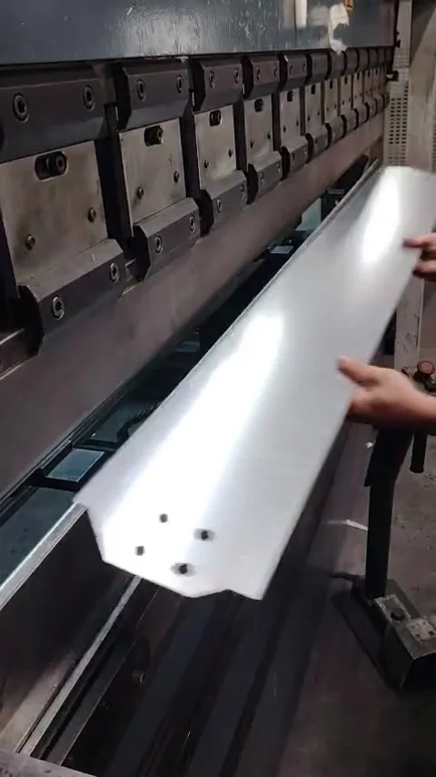 Worker Placing Metal Sheet into Press Brake Bending Machine Stock Footage 342789696