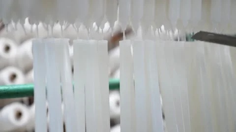 Worker placing a plastic mold cup onto hanging wicks during the candle dipping Stock Footage 343370249