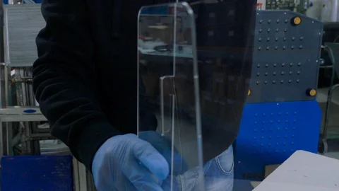 Worker placing plexiglas on the table to space people Stock-Footage 129594059