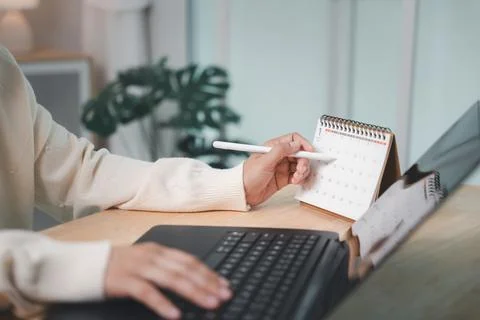 Worker planning to write paper work report presentation meeting dates on ca.. Stock Photos