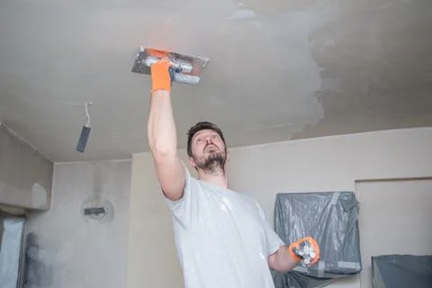 Worker Plastering Ceiling Stock Photos