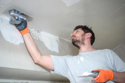 Worker Plastering Ceiling Stock Photos
