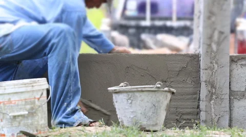 Worker to plastering wall outside of home Stock Footage 54338644
