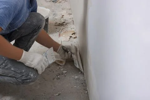 Worker plastering wall with putty knife indoors, closeup. Space for text Fotos de archivo