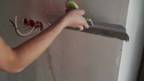 Worker Plastering Wall with Spatula Stock Footage 333386958