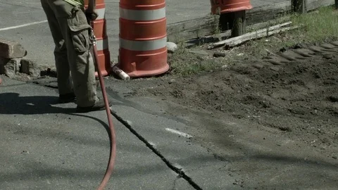 Worker With Pneumatic Hammer Drill Drilling Into Asphalt At Construction Site  Stock Footage 76767297