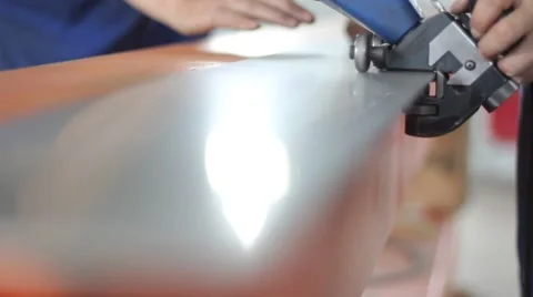 A worker polishes the edge of the metal sheet Stock Footage 62812335