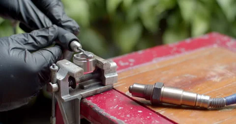 Worker polishes the O2 sensor adapter with a grinder to shape it for a better. Stock Footage 313495665
