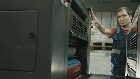 Worker on polygraph industry process, color printing Stock Footage 69091910