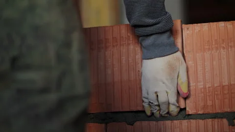 Worker Positioning Clay Brick on Mortar Layer Stock Footage 321858312