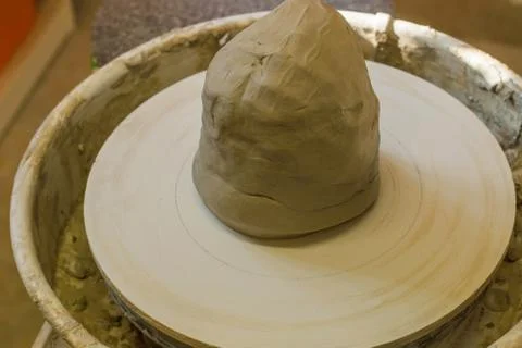 Worker potter in the workshop sculpting ceramic vase. Stock Photos