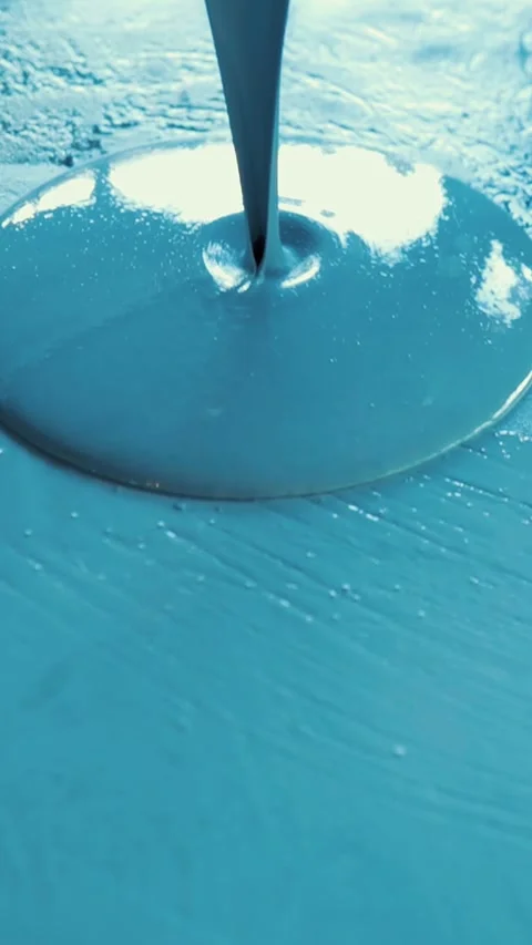Worker pouring blue epoxy resin on floor Stock Footage 316672635