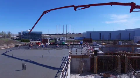 Worker pouring concrete on conrtruction site Stock Footage 64125800