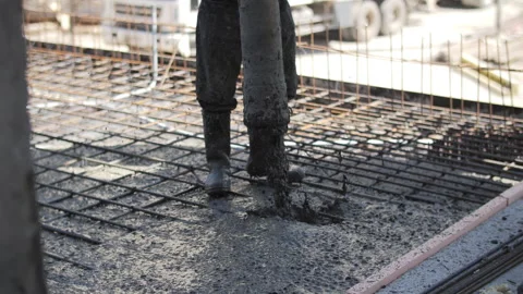 Worker pouring concrete at construction site foundation Stock Footage 311591855