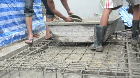 Worker pouring concrete works at construction site Stock Footage 137817399