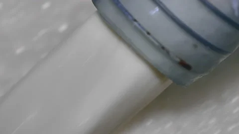 Worker pouring milk into a container. Worker of mozzarella process Video stock 131345218