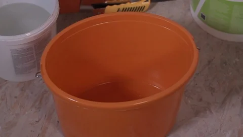 Worker Pouring The Water Into a Plastic Bucket Stock Footage