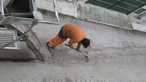 Worker pours colored concrete that is poured from a truck mixer to fill the c Video stock 149968642