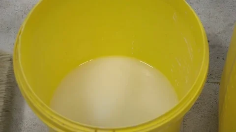 Worker pours the liquid into a bucket Vídeo Stock 73100192
