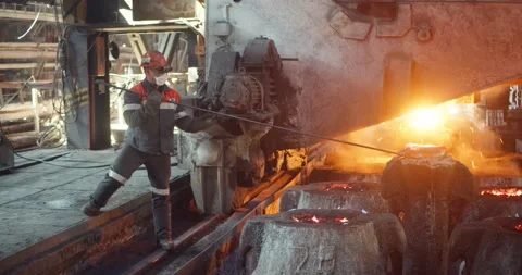 A worker pours metal into molds. Stock Footage 172054898