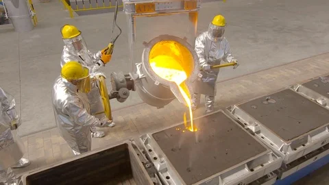 Worker pours molten metal into a container at the metallurgical plant. Stock Footage 76466823