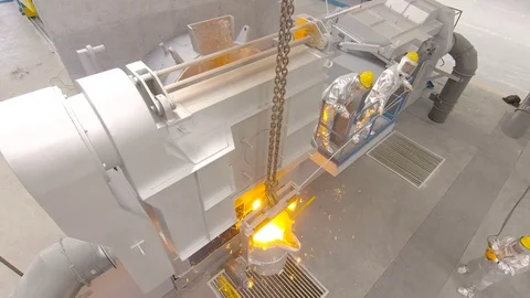 Worker pours molten metal into a container at the metallurgical plant. Video stock 76466866