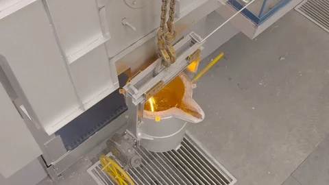 Worker pours molten metal into a container at the metallurgical plant. Video stock 76466879