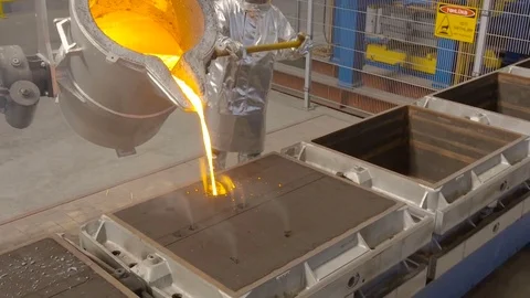 Worker pours molten metal into a container at the metallurgical plant. Video stock 76466935