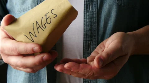 Worker pours peanuts from wage packet Stock Footage 51696584