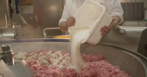 Worker pours spice mix into minced meat in a food plant, Close Up Stock Footage 340005214