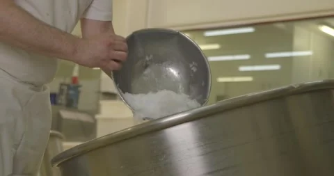 Worker Pours Sugar Into an Industrial Mixing Drum Video stock 340261665