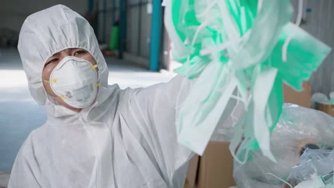 Worker in PPE exhausted and tried in Waste recycling plants during covid-19 a Stock Footage 158175341