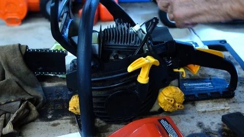 Worker Preforming Maintenance On Chainsaw Stock Footage 93676287