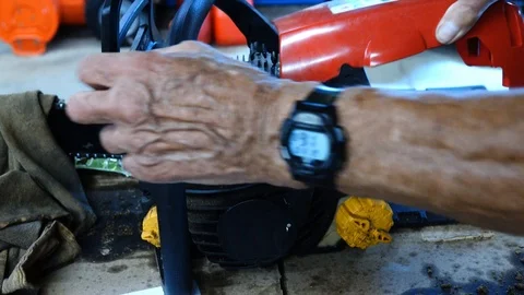 Worker Preforming Maintenance On Chainsaw Video stock 93679148