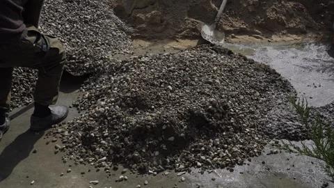 A worker prepares a cement mixture for the foundation Stock Footage 307384955