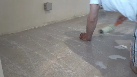 The worker prepares the floor for tiling Stock Footage 74047571