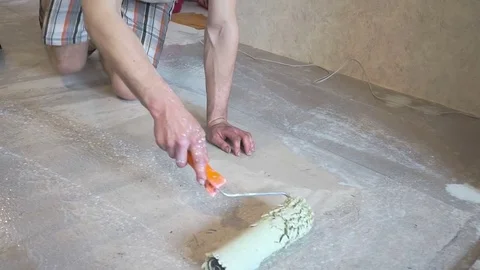 The worker prepares the floor for tiling Stock Footage 74053284